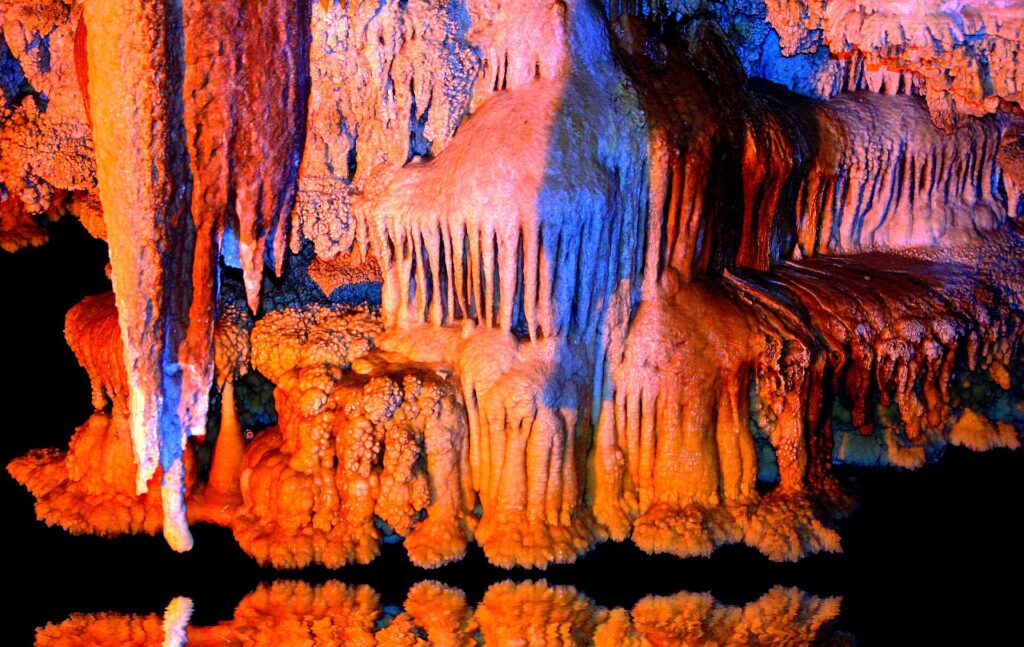 Lit formations above the water.