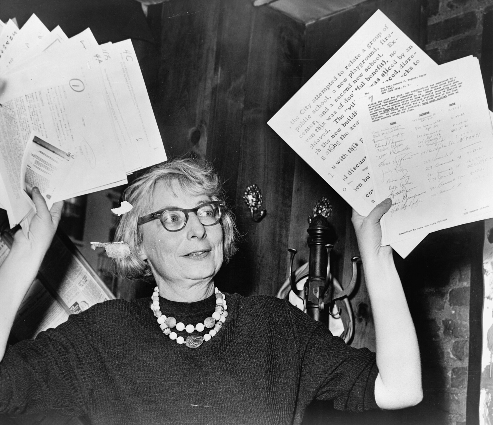 Jane Jacobs holding up evidence at a press conference to save the West Village.