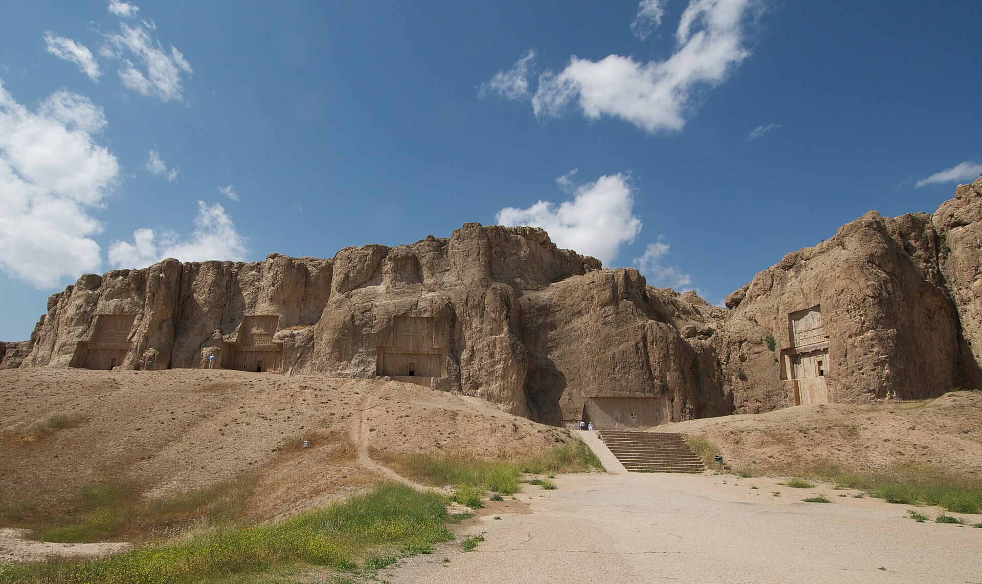 The royal tombs cut into the cliff.