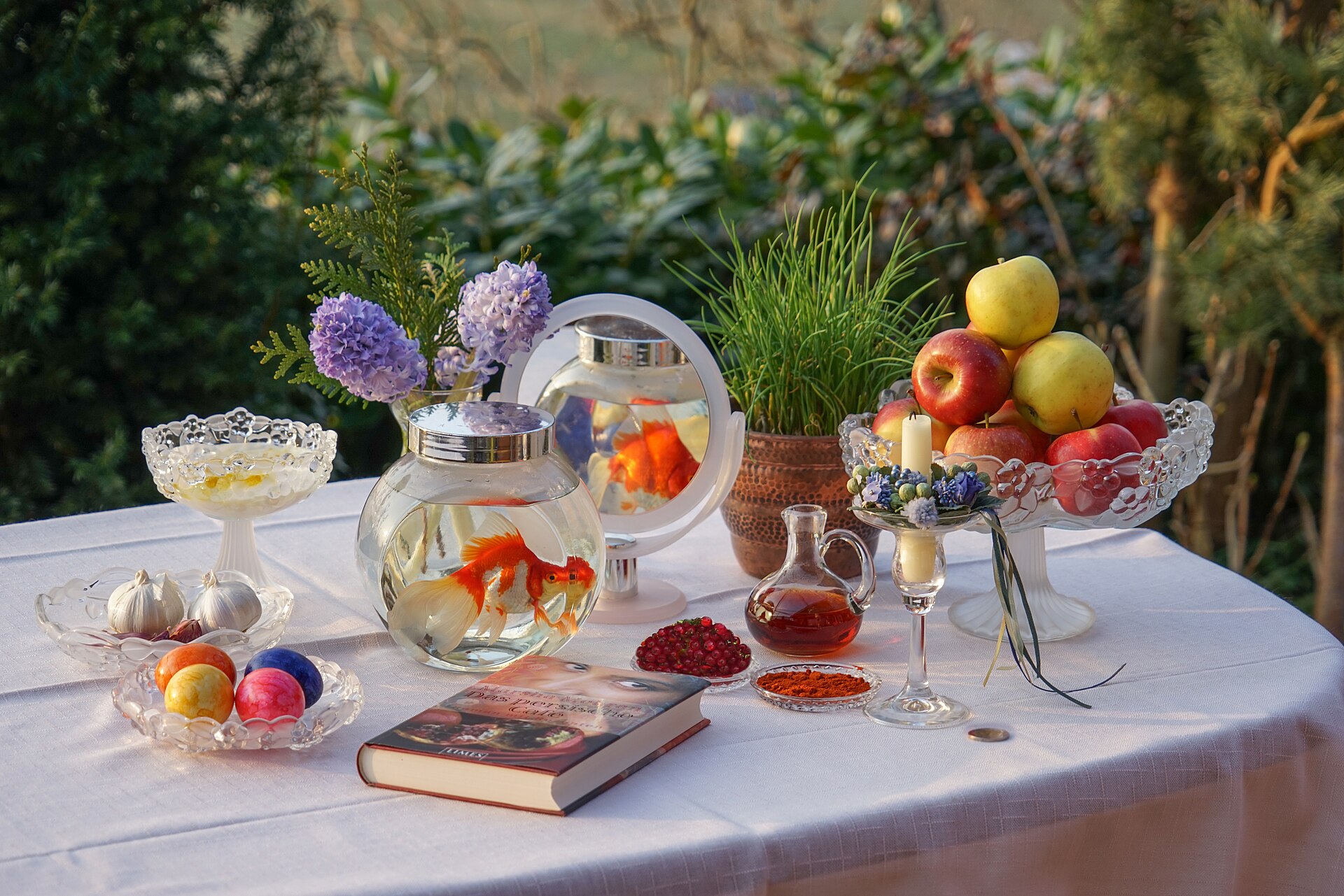 A haft-sin table with goldfish and sabzeh.