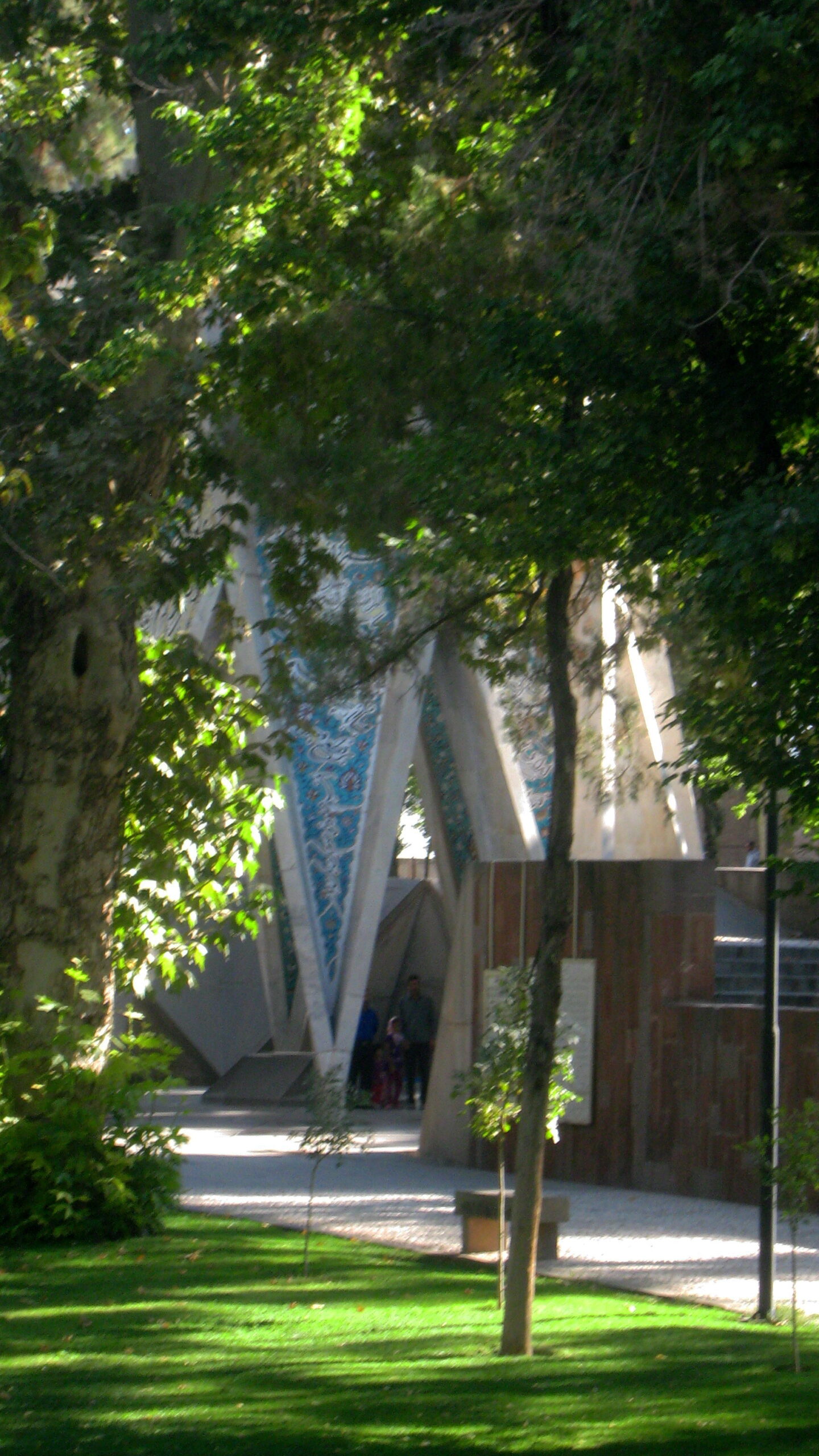 The tomb of Omar Khayyam among trees.