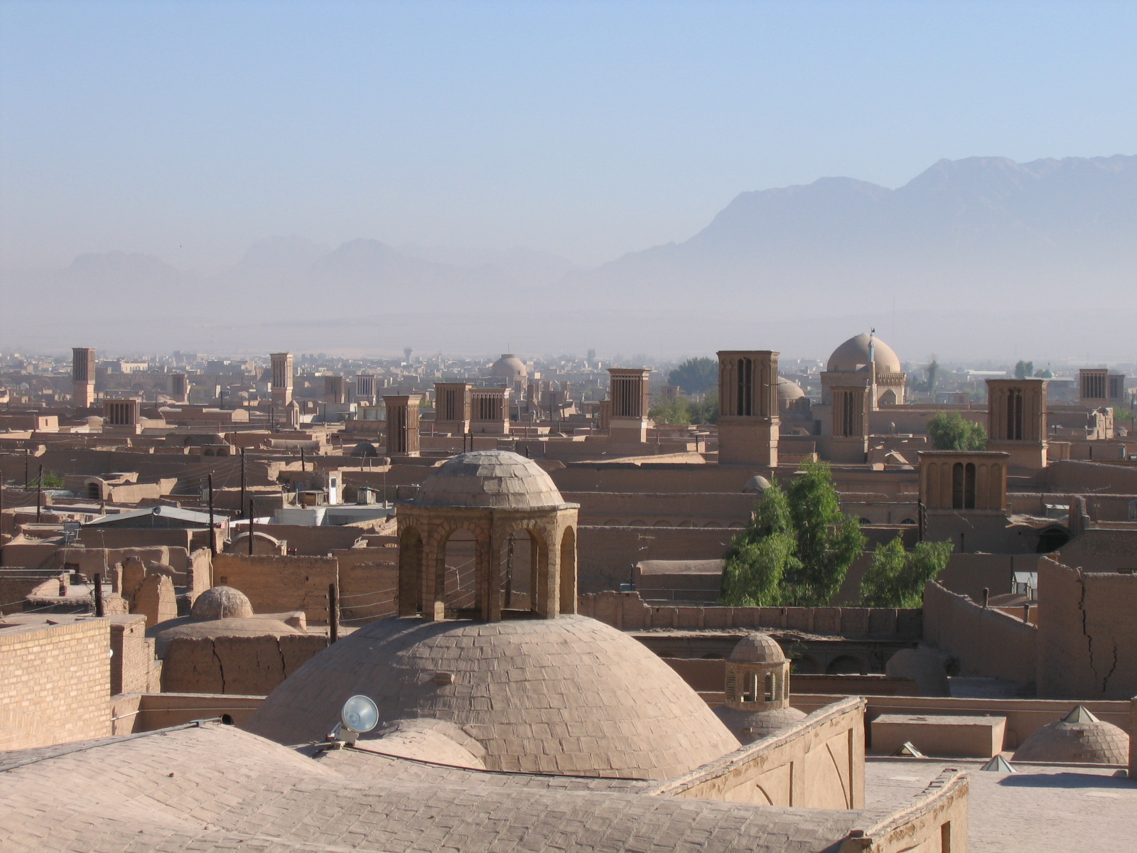 Windcatchers and domes over the old city at dawn.